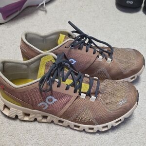 On Running Tan and Yellow Athletic Shoes